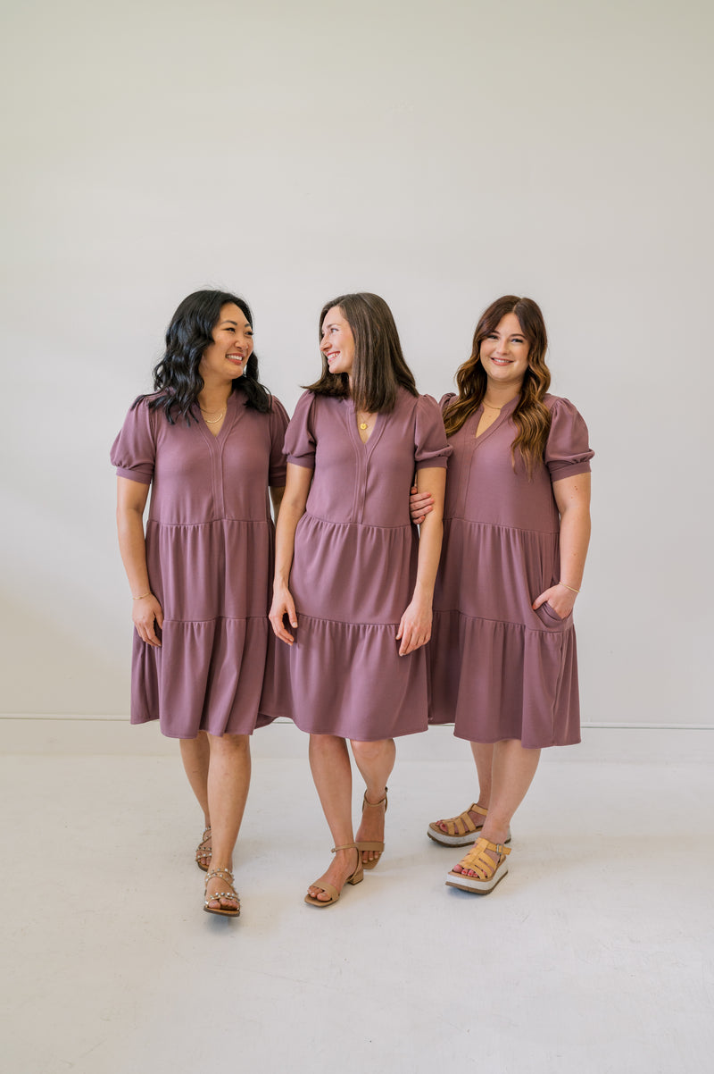 Group shot of our new soft plum knee length dress. Shown on an xs, m and xl model.