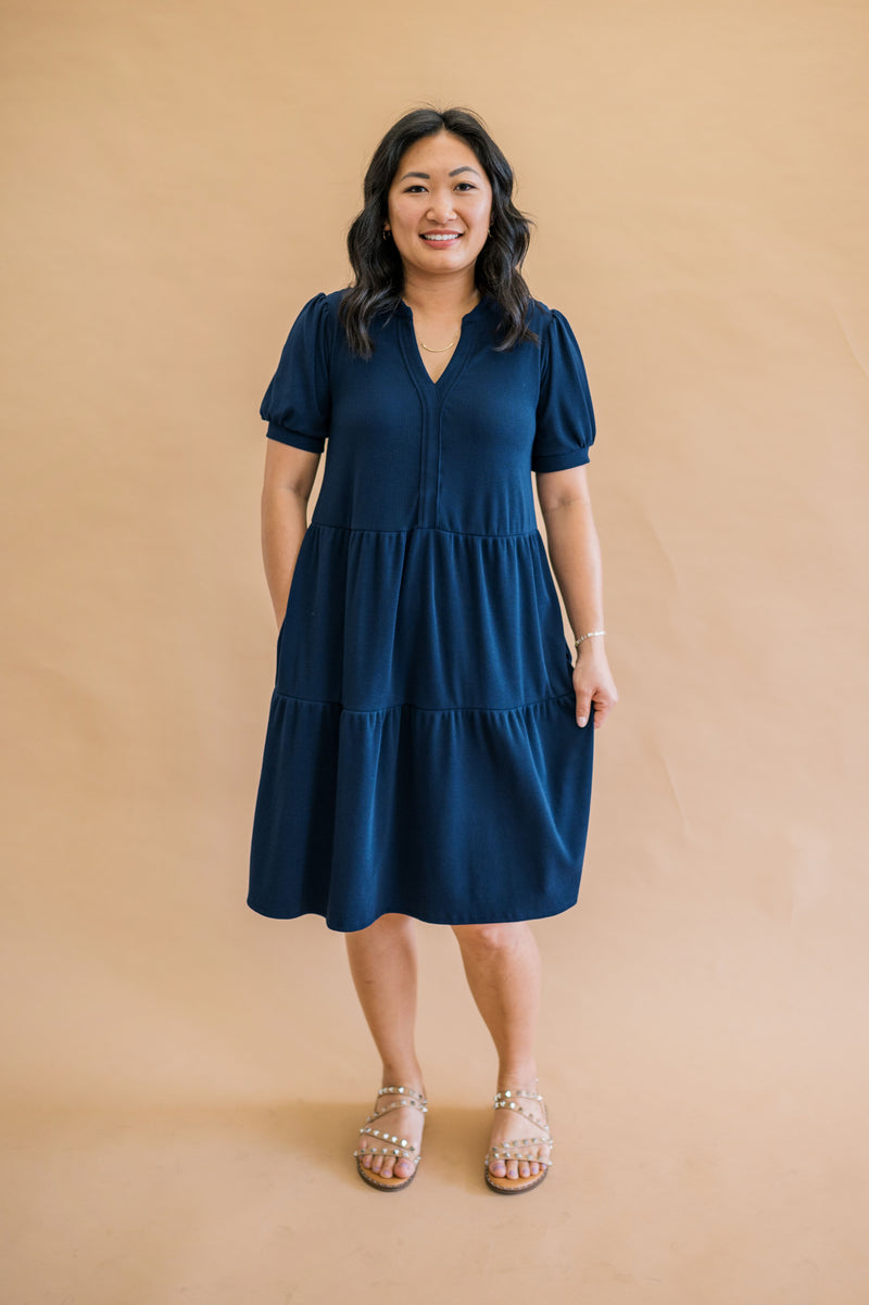 Navy tiered split neck dress, with puff sleeves. The perfect family photo dress for navy family photos