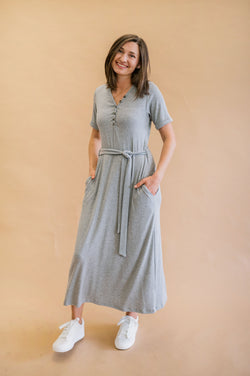 Gray ribbed henley dress on our xs model, this longer midi style dress has functional buttons, rolled sleeves and a removable tie. 