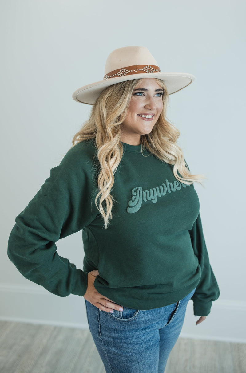 Blonde Model wearing Anywhere Sweatshirt in Forest Green with Light green contrast screen print