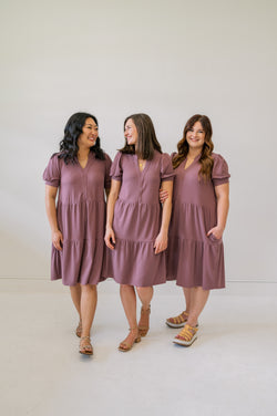 Group shot of our new soft plum knee length dress. Shown on an xs, m and xl model.