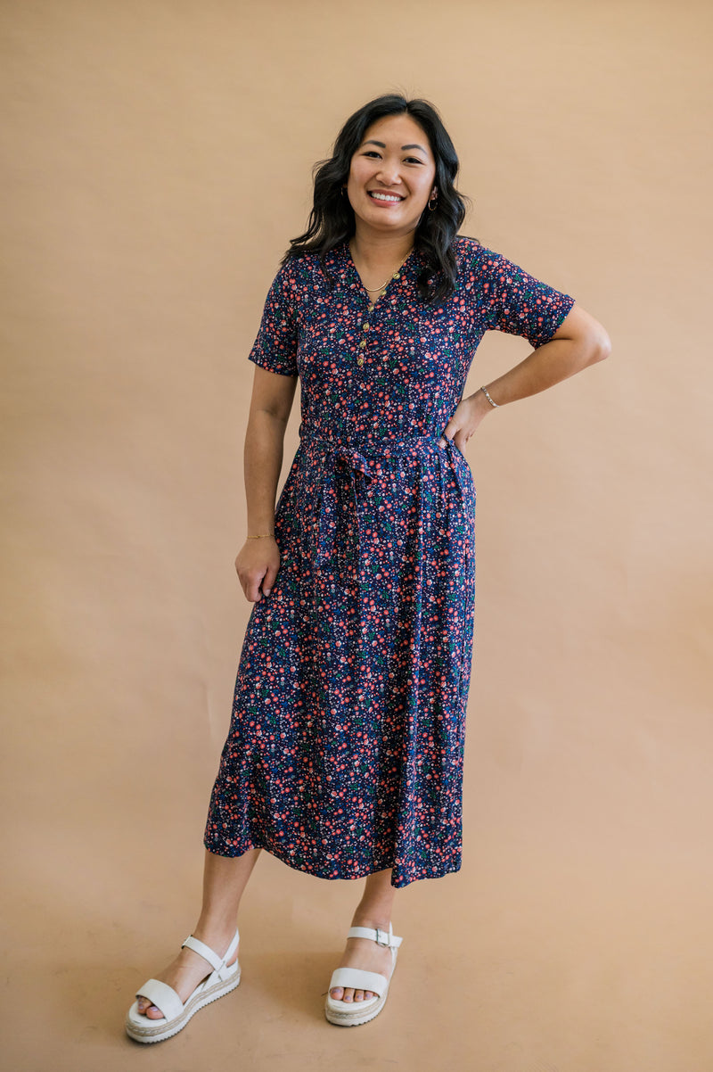 Size Medium model wearing our best selling floral print henley dress. Complete with pockets, functional buttons for nursing, and pockets.