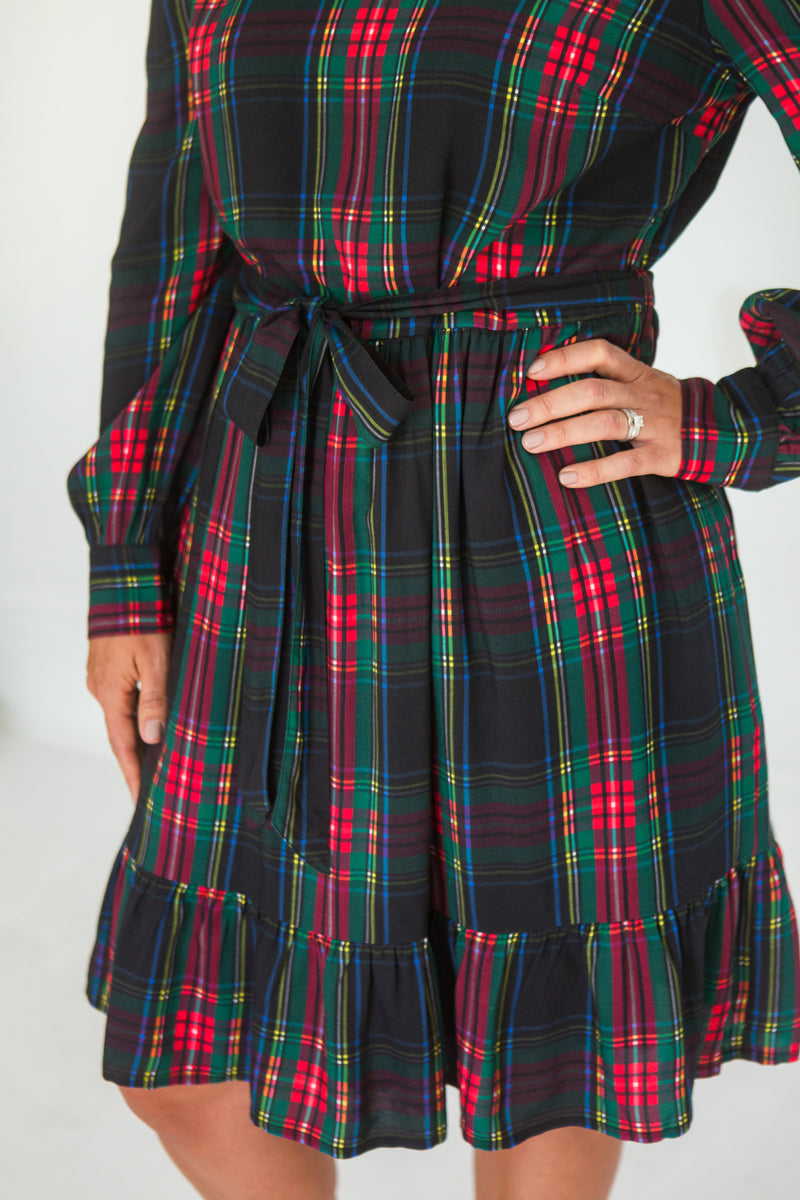 Plaid Holiday dress features a removable waist tie and ruffle hem as well as cuffed sleves. 