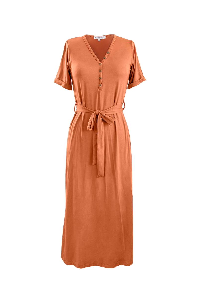 Flatlay of  MW Anywhere dress in Rust. Dress has buttons, a waist tie, and comes to mid thigh.